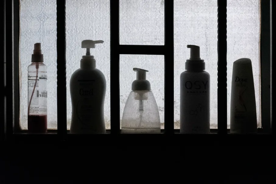 3 bottles on black wooden shelf